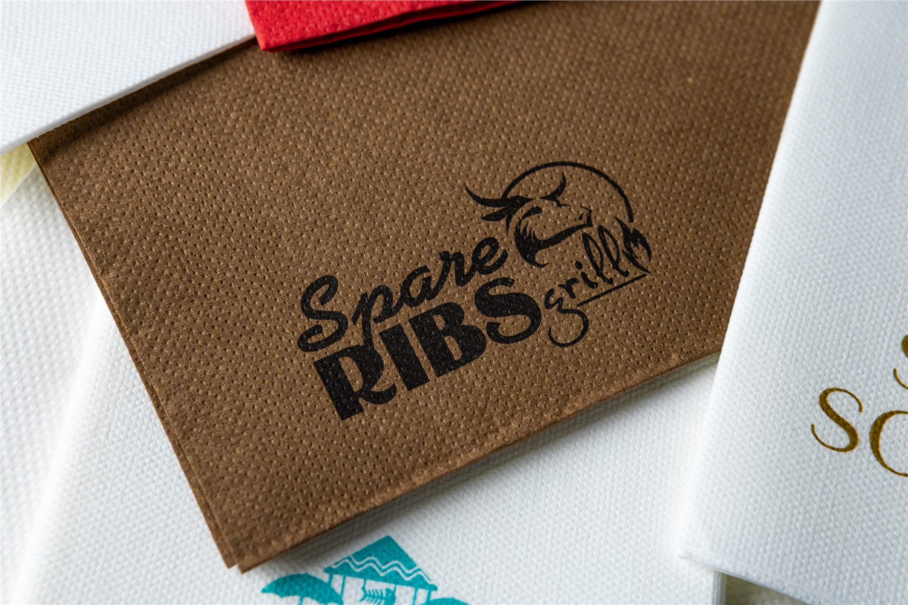 Close-up of a logo-printed napkin in brown