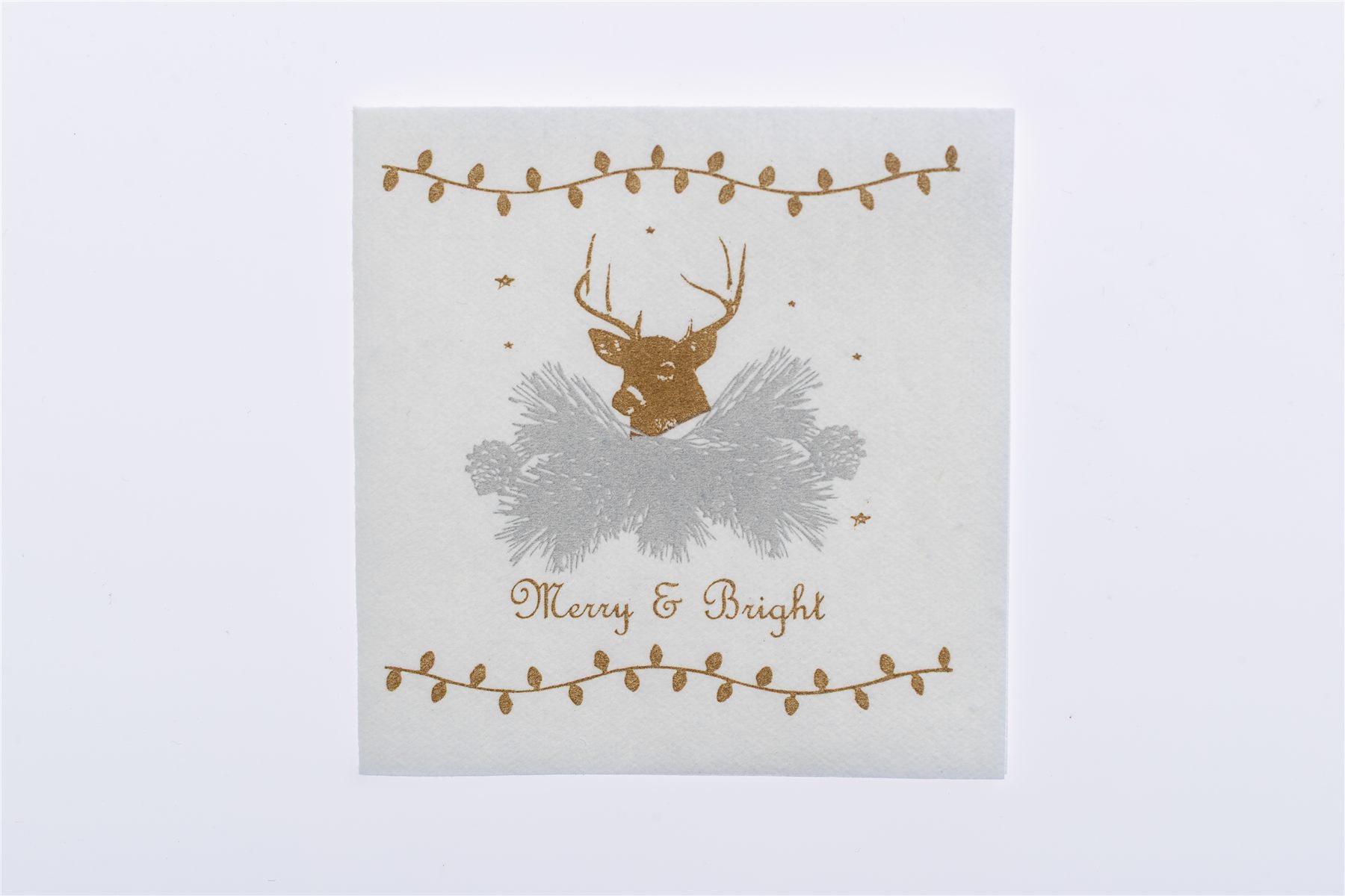 Napkin printed with a gold stag and Merry & Bright script