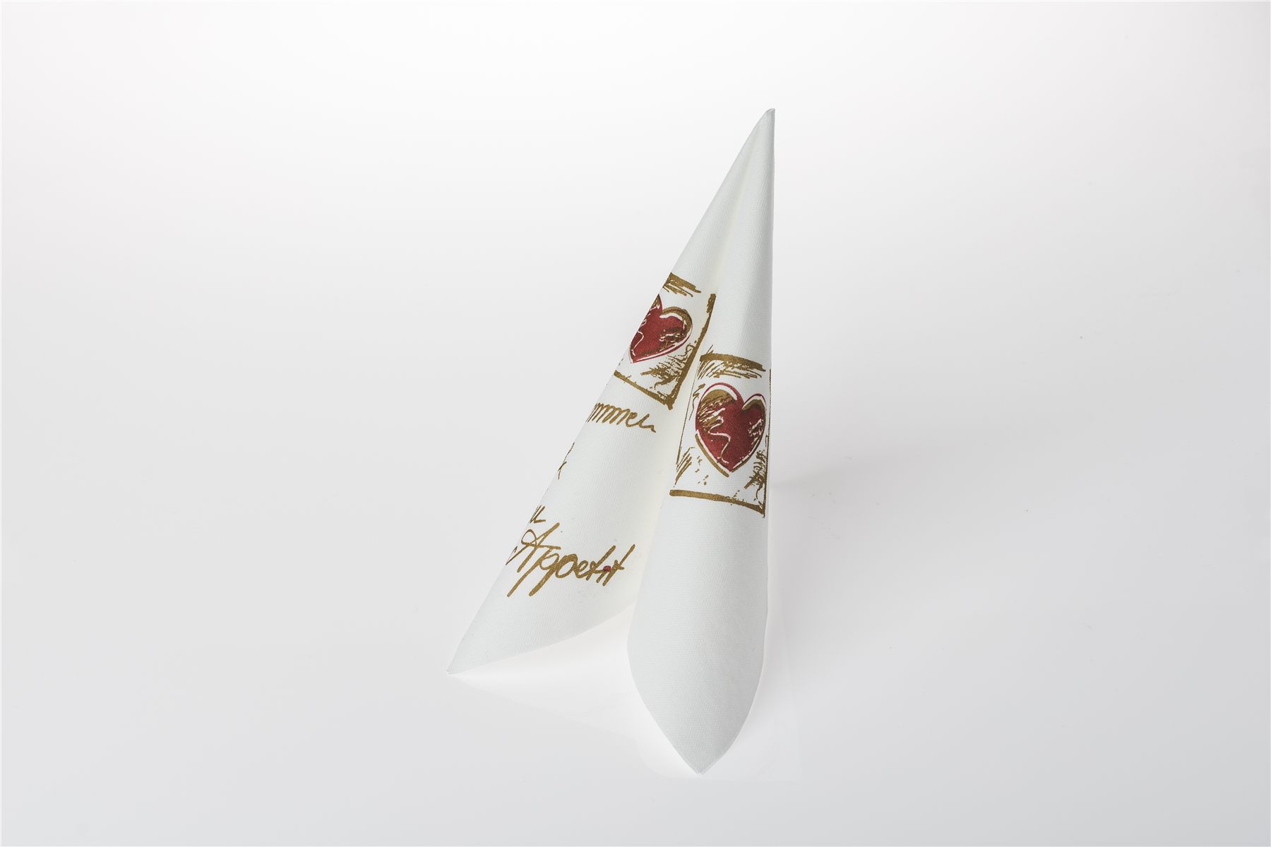 Napkin folded with a bon appétit script and heart