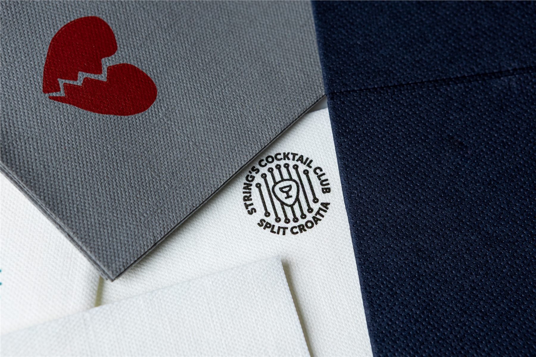 Assorted logo-printed napkins in gray, white and navy